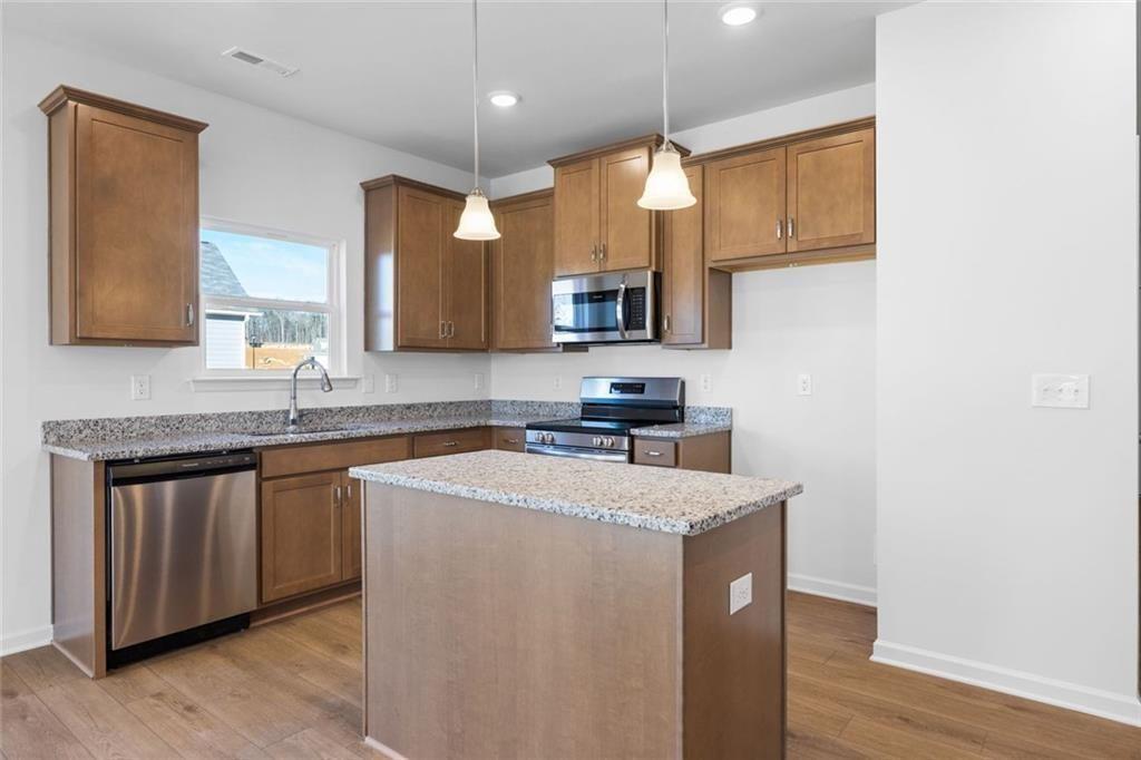 22 Willow Circle Rock Spring, GA 30739 - Photo 12 of 41 a kitchen with stainless steel appliances granite countertop a sink a stove a microwave a sink a refrigerator and island