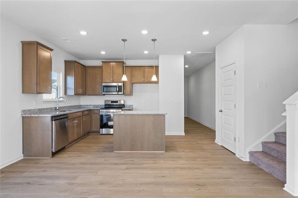 22 Willow Circle Rock Spring, GA 30739 - Photo 13 of 41 a kitchen with granite countertop a stove top oven and cabinets