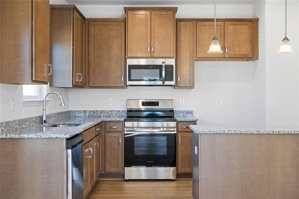 22 Willow Circle Rock Spring, GA 30739 - Photo 14 of 41 a kitchen with granite countertop a stove top oven microwave and cabinets