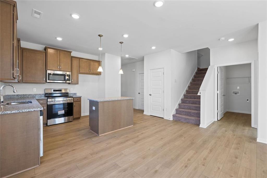 22 Willow Circle Rock Spring, GA 30739 - Photo 15 of 41 a kitchen with stainless steel appliances kitchen island granite countertop a stove a sink and a refrigerator