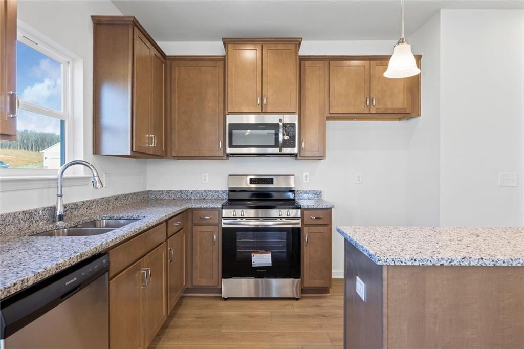 22 Willow Circle Rock Spring, GA 30739 - Photo 16 of 41 a kitchen with stainless steel appliances granite countertop a stove a sink and a microwave