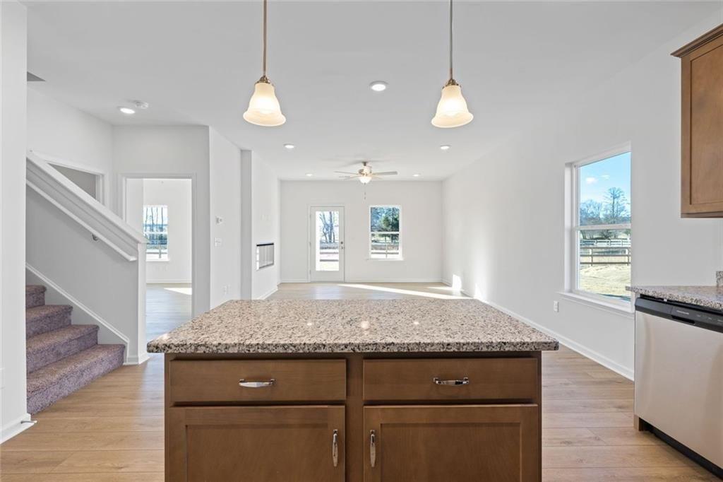 22 Willow Circle Rock Spring, GA 30739 - Photo 18 of 41 a kitchen with kitchen island granite countertop wooden floor and a refrigerator
