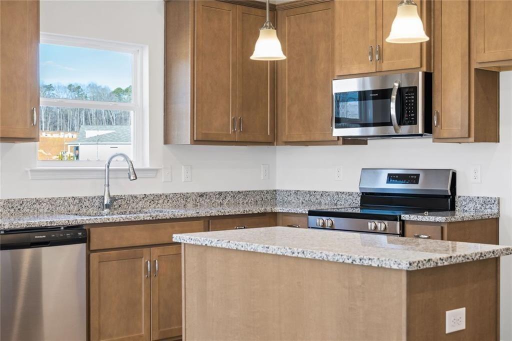 22 Willow Circle Rock Spring, GA 30739 - Photo 19 of 41 a kitchen with granite countertop a sink and a stove