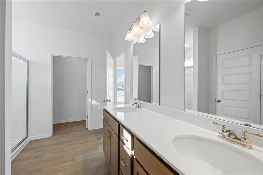 22 Willow Circle Rock Spring, GA 30739 - Photo 32 of 41 a spacious bathroom with a granite countertop sink a mirror and a shower