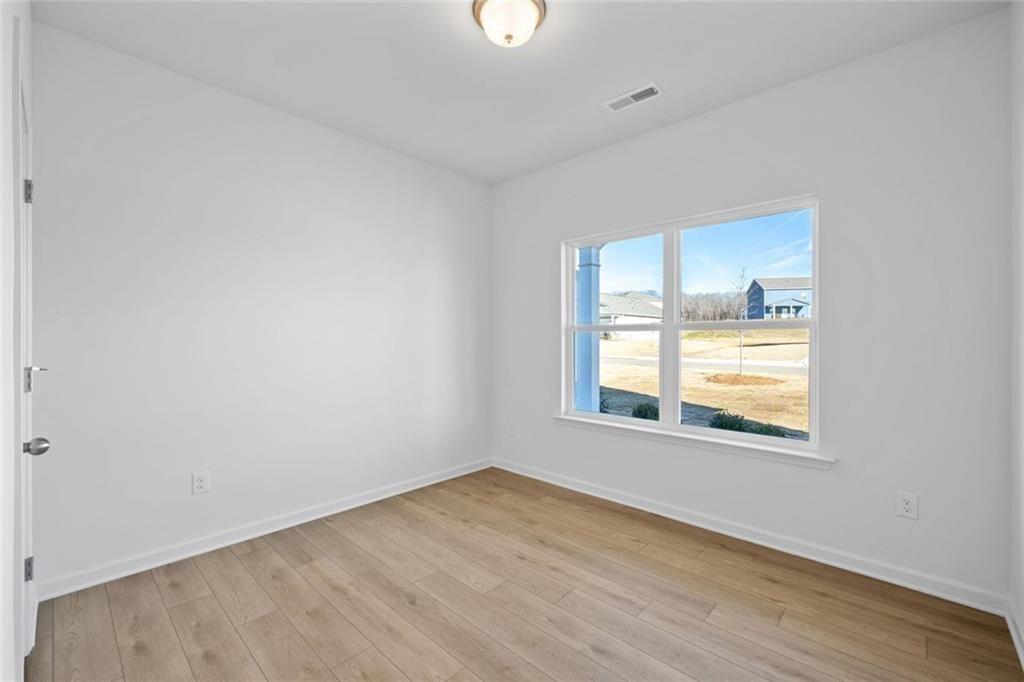 22 Willow Circle Rock Spring, GA 30739 - Photo 6 of 41 an empty room with wooden floor and windows