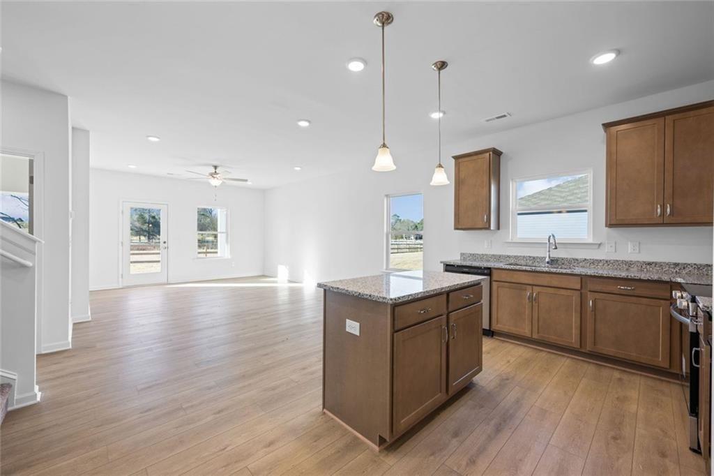 22 Willow Circle Rock Spring, GA 30739 - Photo 10 of 41 a large kitchen with stainless steel appliances granite countertop a large center island a sink a stove and a wooden floors