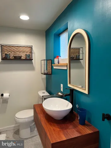a bathroom with a toilet a sink and mirror