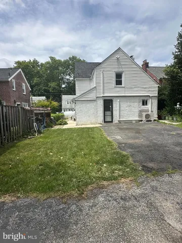 a view of a house with a yard and sitting area
