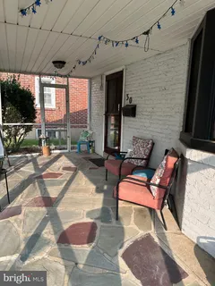 a building outdoor space with patio furniture and potted plants
