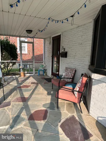 a building outdoor space with patio furniture and potted plants