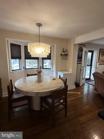 a dining room with furniture window and wooden floor