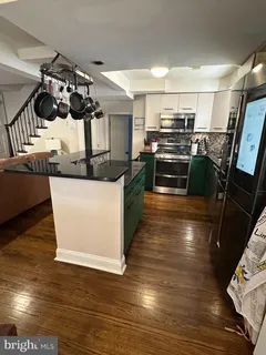 a kitchen with granite countertop a stove and cabinets