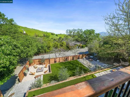 a view of a backyard with seating area