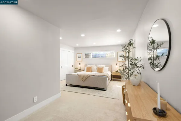 a living room with furniture a table and a large mirror