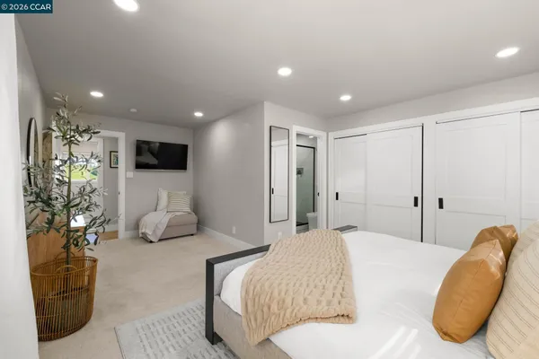 a spacious bedroom with a bed and a couch