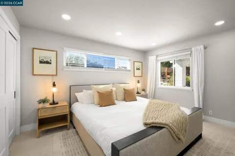 a bedroom with a bed and a couch