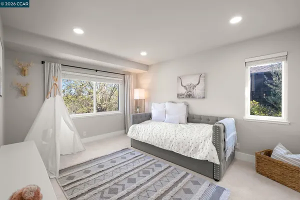 a bedroom with a large bed and a couch