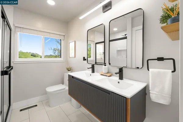 a bathroom with a sink toilet and mirror