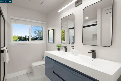 a bathroom with a sink mirror and toilet