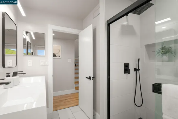 a bathroom with a granite countertop shower and a sink