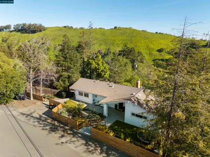 an aerial view of a house with a mountain