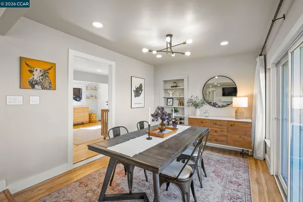 a view of a dining room with furniture and chandelier