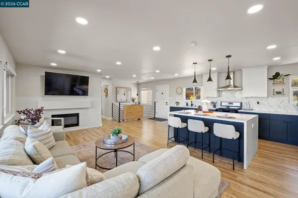a living room with fireplace furniture and a wooden floor