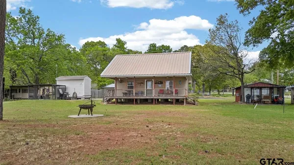 a view of a house with a yard and sitting area