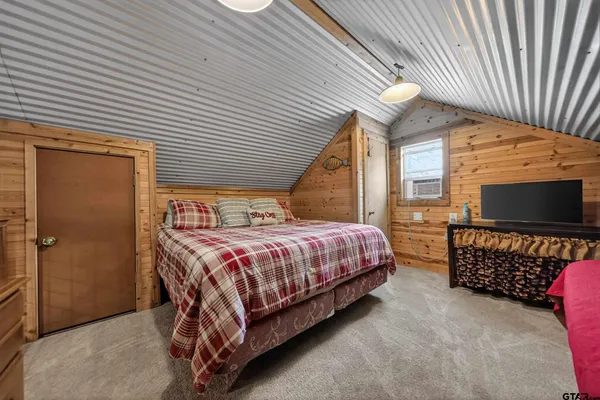 a spacious bedroom with a bed and a couch