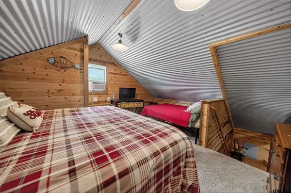 a bedroom with a bed and a night stand