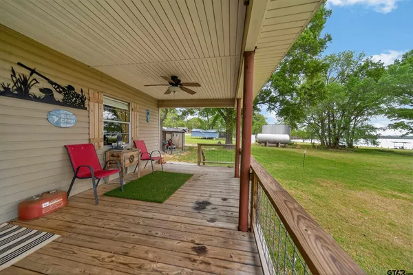 a view of a porch with furniture and garden