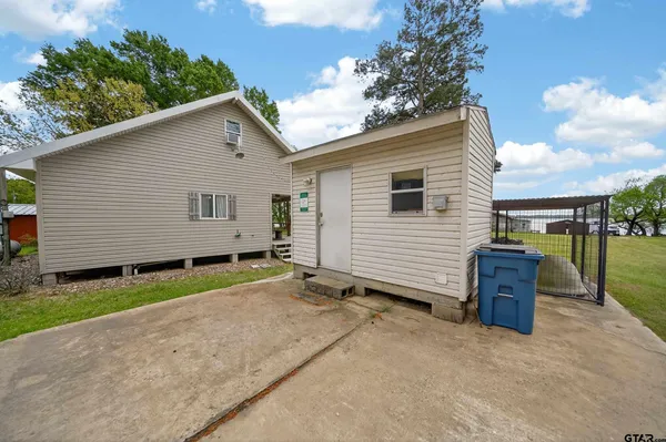 a backyard of a house with barbeque oven