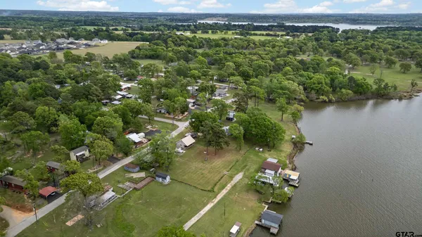 an aerial view of a houses with a yard