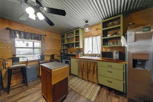 a kitchen with cabinets table and chairs