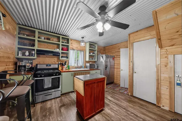 a kitchen with stainless steel appliances granite countertop a stove and a refrigerator