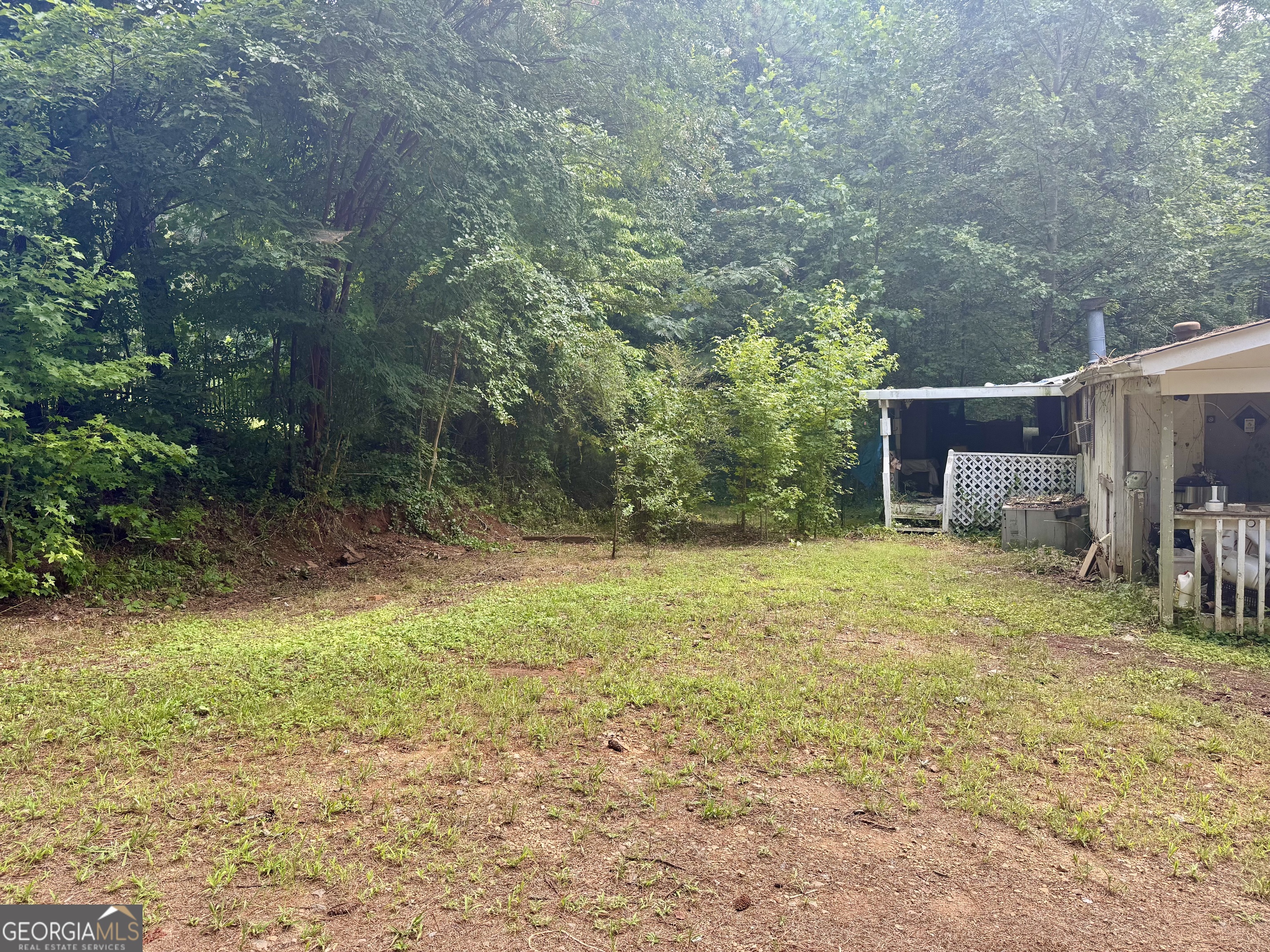 5324 Robin Trail Braselton, GA 30517 - Photo 5 of 10 a backyard of a house with fountain table and chairs