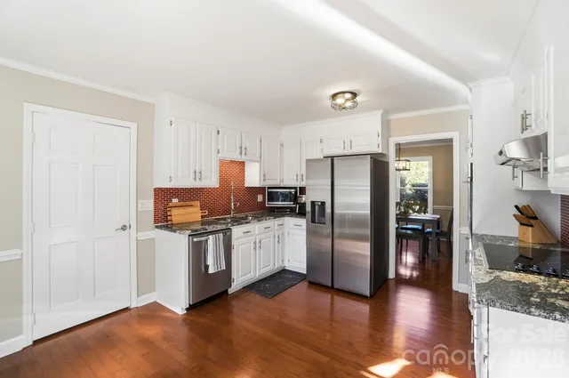 a kitchen with a refrigerator and a sink