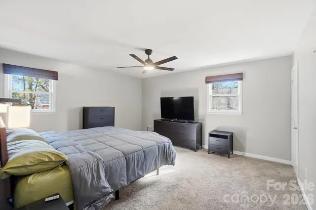 a bedroom with a bed and a television