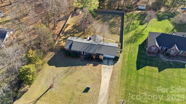 a view of roof deck with table and chairs and potted plants
