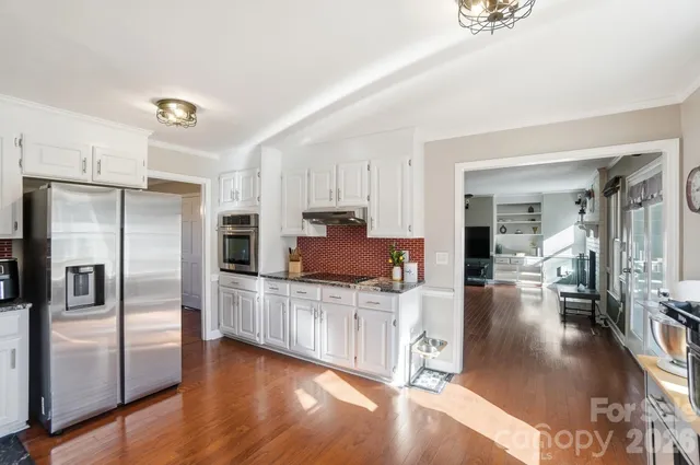 a kitchen with stainless steel appliances a refrigerator and a sink