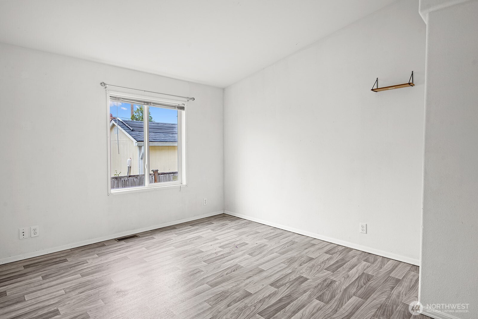 124 South 6th Street McCleary, WA 98557 - Photo 18 of 33 a view of an empty room with wooden floor and a window