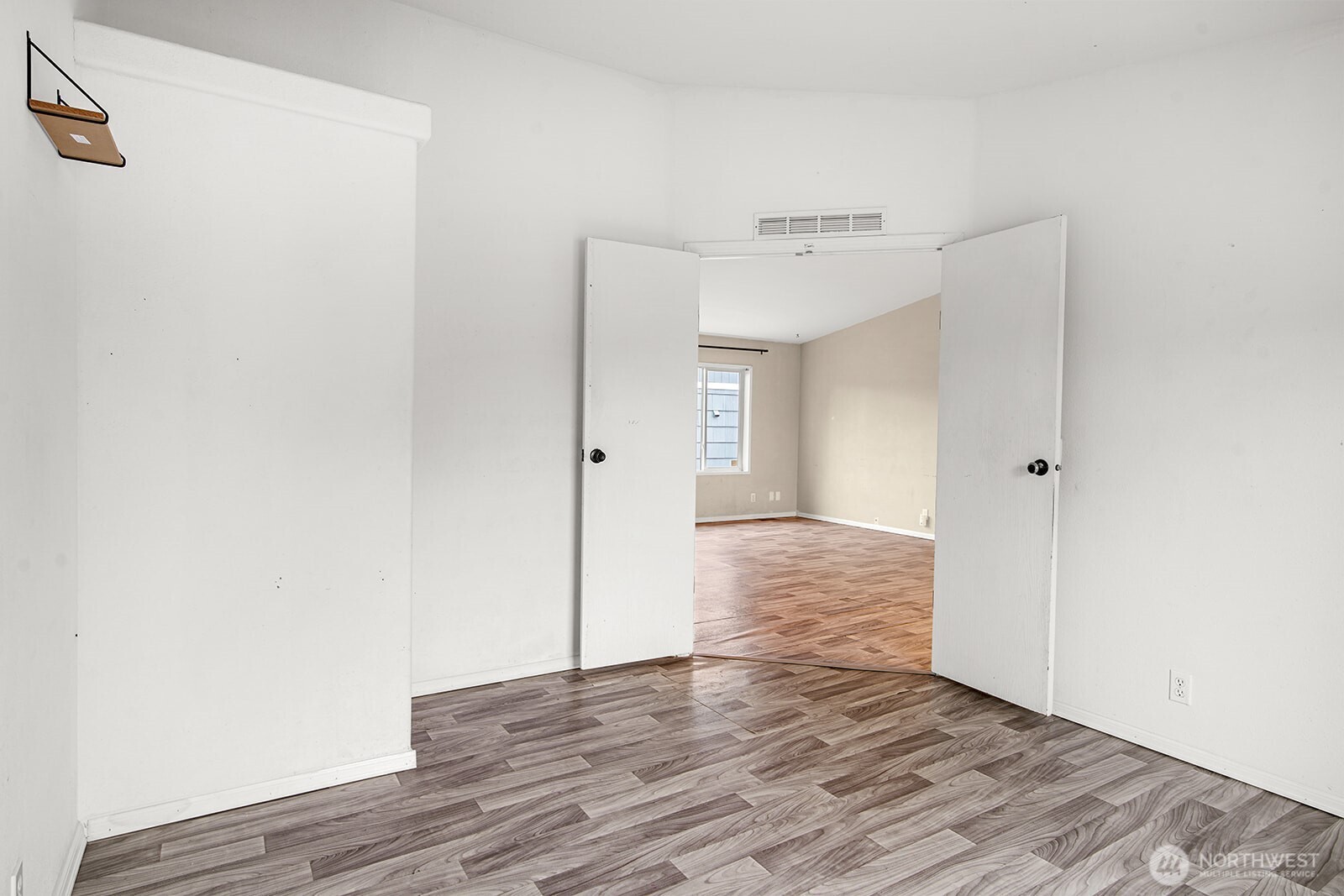 124 South 6th Street McCleary, WA 98557 - Photo 19 of 33 a view of an empty room with wooden floor and a bathroom