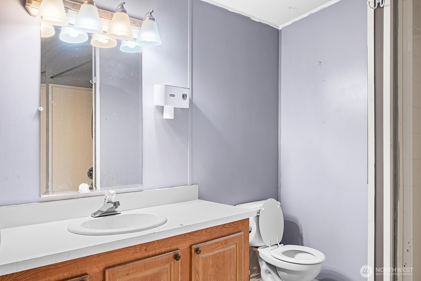 124 South 6th Street McCleary, WA 98557 - Photo 22 of 33 a bathroom with a granite countertop sink a toilet and a mirror