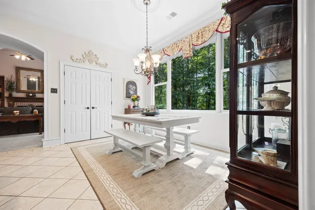 a kitchen with stainless steel appliances granite countertop a stove a sink dishwasher and a refrigerator with wooden cabinets