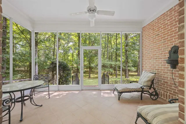 a bathroom with a tub a mirror and a shower