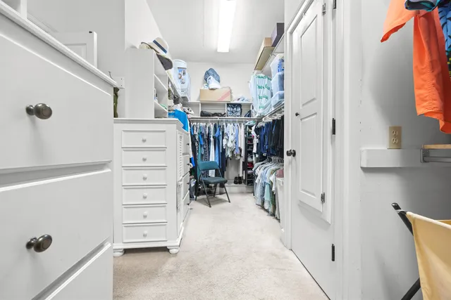 a living room with furniture and a mirror