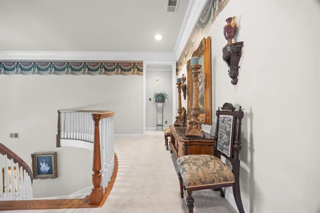 a spacious bedroom with a bed and a chandelier