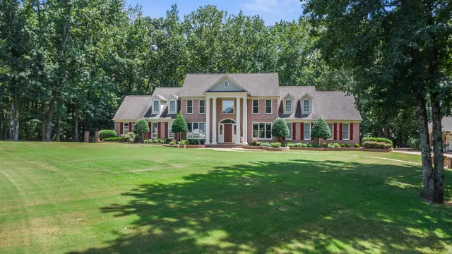 a front view of a house with a garden and porch