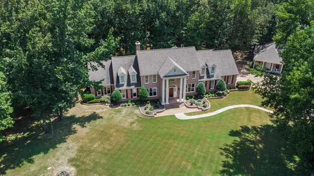 a view of a house with swimming pool and sitting area