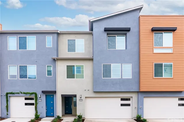 a kitchen with stainless steel appliances granite countertop a stove top oven a sink a refrigerator and white cabinets with wooden floor